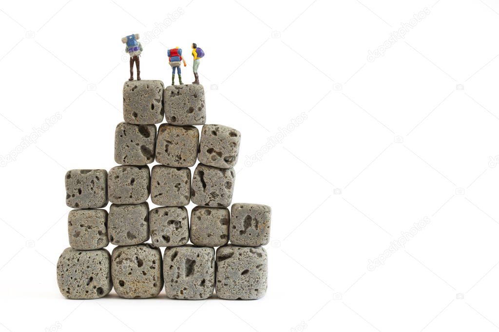 miniature people with cube rock on whote background