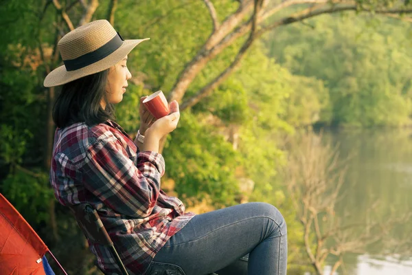 Beautiful woman drinking coffee with nature background