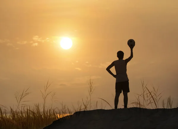 silhouette man throw ball with sunrise or sunset background