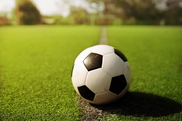 Soccer or Football on green field — Stock Photo, Image