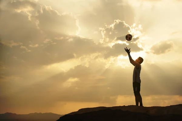 Silhouette man throw ball with sunrise or sunset background — Stock Photo, Image