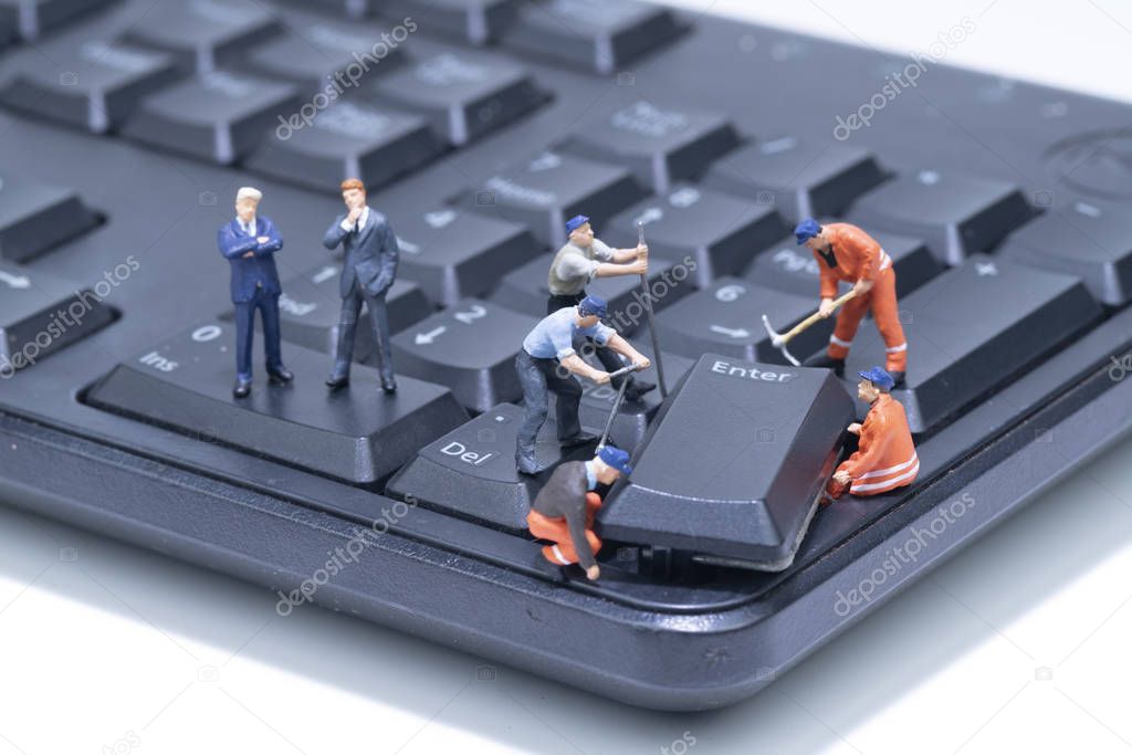 Miniature people repair Computer Keyboard