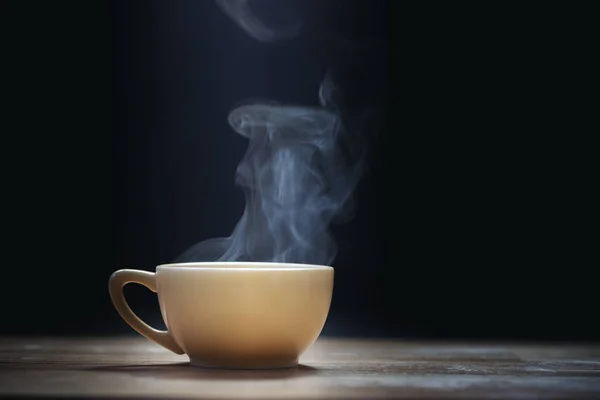 Cup of coffee with steam on black background — Stock Photo, Image