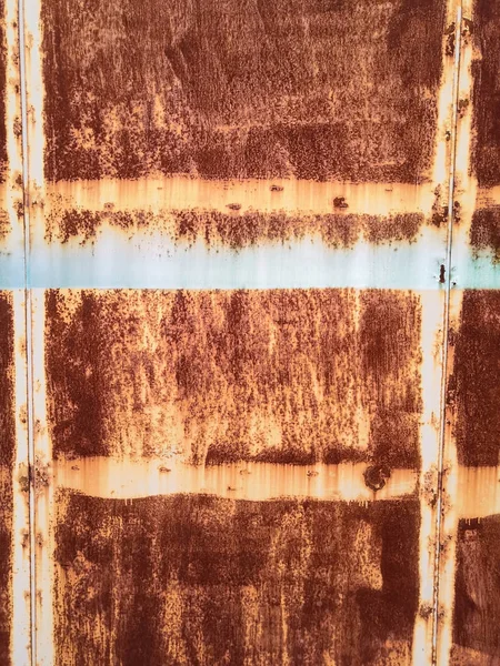 Rusty brown metal wall with yellow patterns. metal rust texture background.