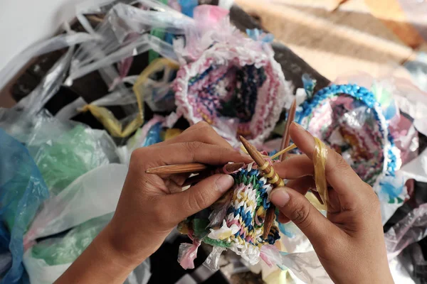 Cut nylon bag into yarn and woman hand knit to basket, good idea to recycling nylon bag to reduce environmental pollution