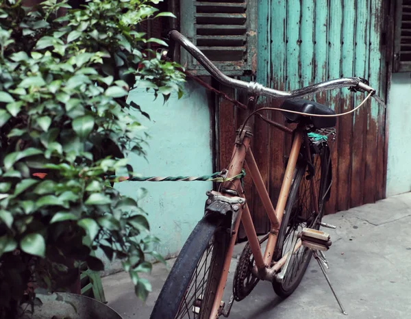 Amazing close up old bicycle front of antique house in vintage t