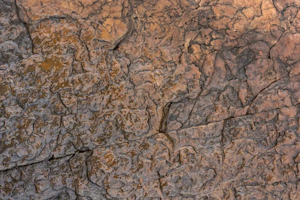 Fundo natural. Textura de arenito marrom alisado pela água — Fotografia de Stock