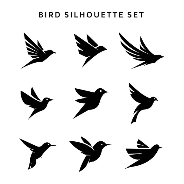 Set di uccelli volanti segno logo silhouette vettoriali isolato su bianco . — Vettoriale Stock