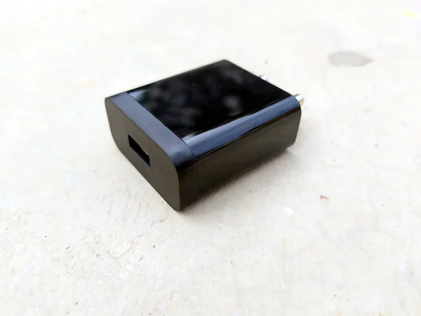 image of black fast mobile charger on the road