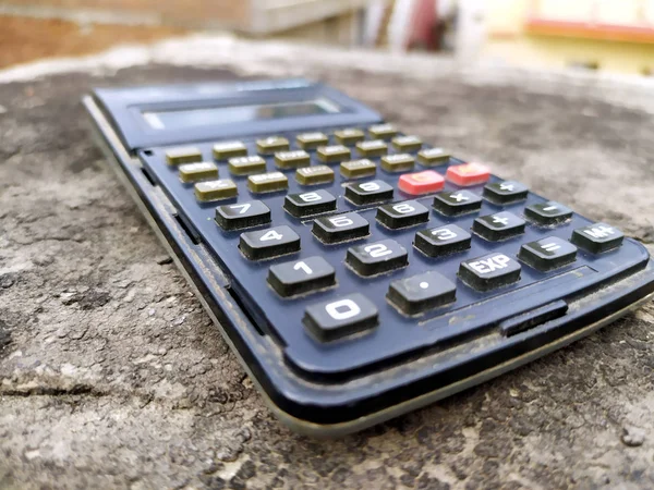 image of scientific calculator on black stone