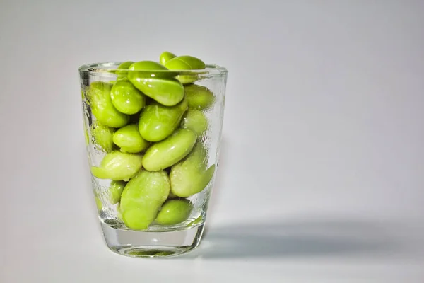 green soybeans in a small glass container