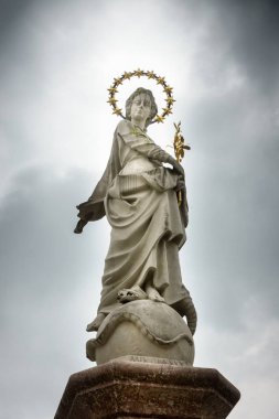 Virgin Mary statue fountain against cloudy sky, Germany clipart