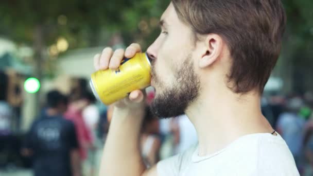 Young man drinking beer in party in park outdoors — Stock Video