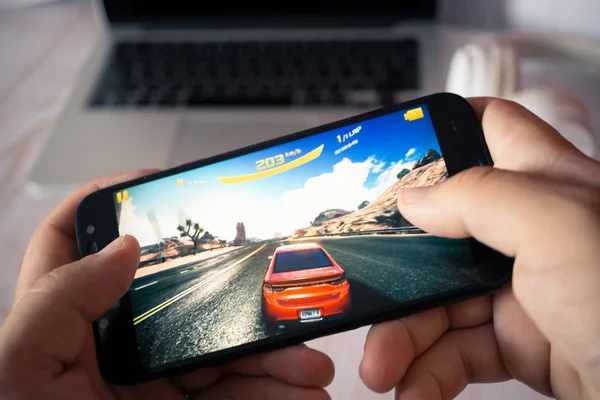 Nizhyn, Ukrayna/16-Temmuz 2019: Akıllı telefon ve playi tutan eller