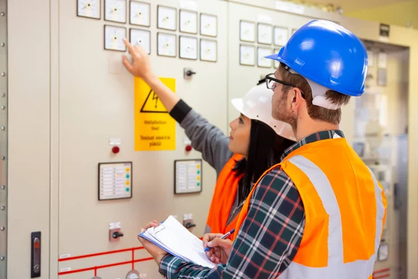 Professional industrial engineers operating in electricity substation