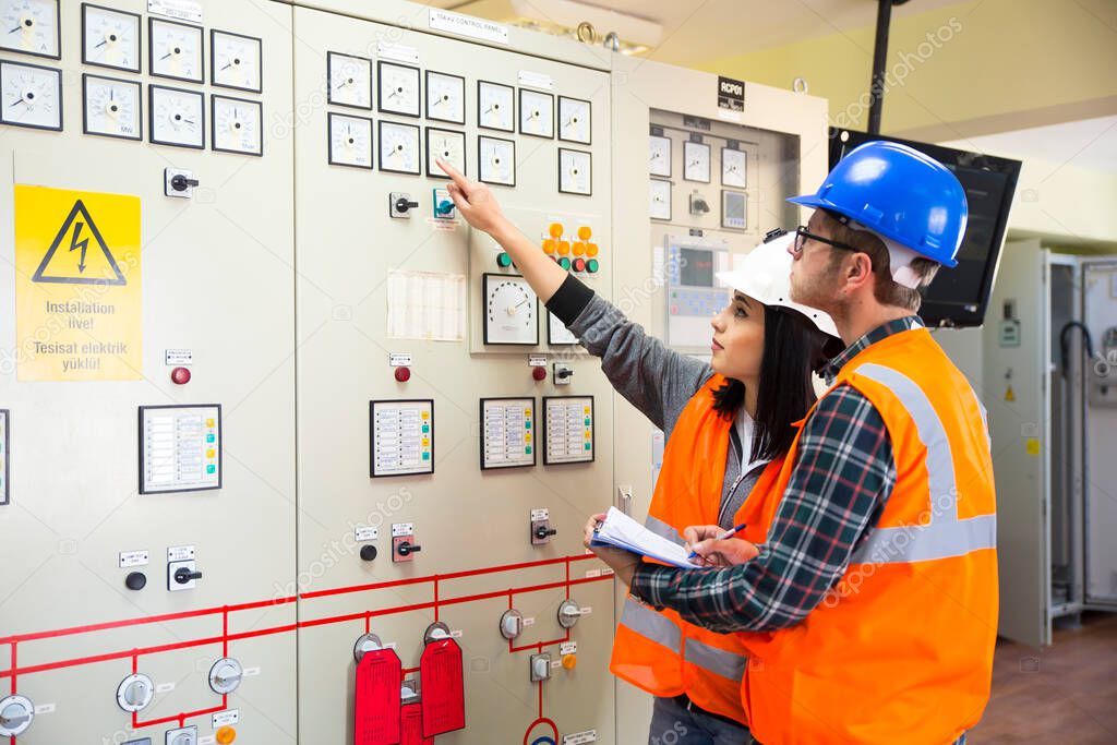 Professional industrial engineers operating in electricity substation