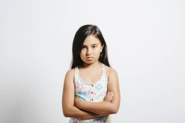 Young girl looking upset over white background. clipart