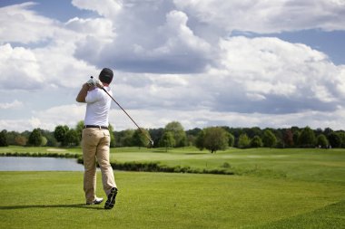 Golf player teeing off clipart