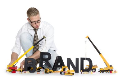 Brand start up: Businessman building brand-word. clipart