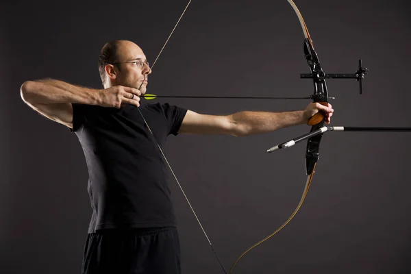 Profile of bowman with bow and arrow.