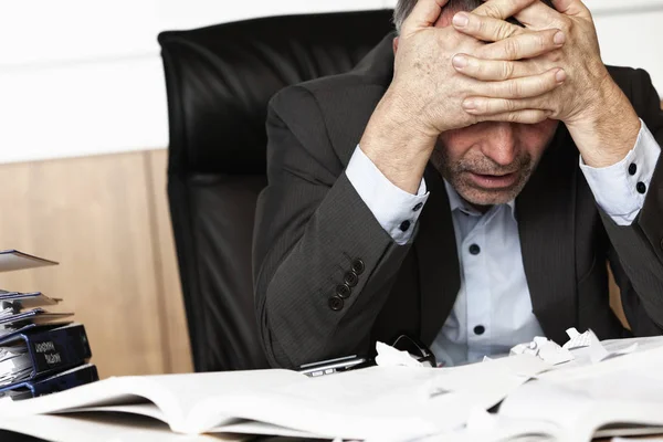 Worried Businessman Sitting Office Desk Full Books Papers Being Overloaded — Stock Photo, Image