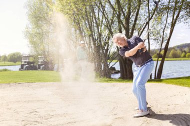 Eski golfçü sığınaktan atış yapıyor.