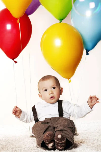 Baby boy with balloons. — Stock Photo, Image