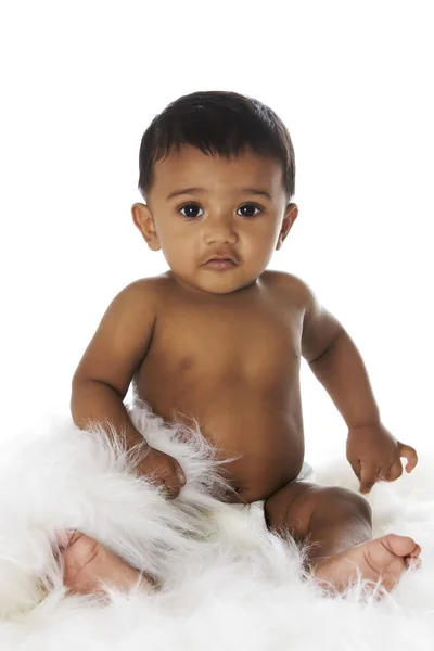 Sweet Indian baby sitting on white fur — Stock Photo, Image