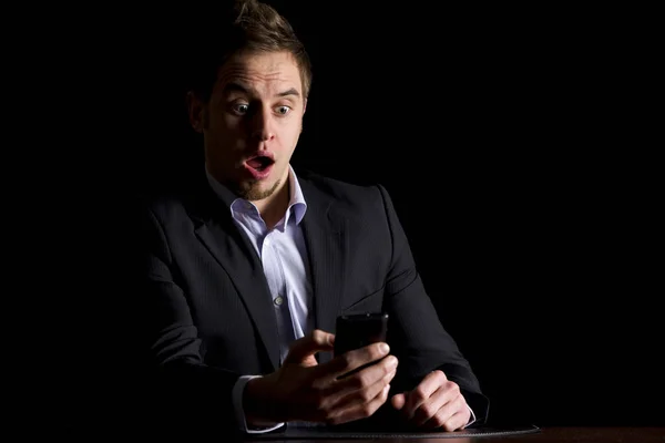Empresário surpreendido com mensagens de texto no telefone . — Fotografia de Stock