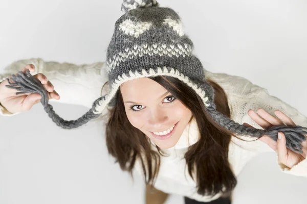 Lovely girl in winter clothes lookig up with raised arms. — Stock Photo, Image