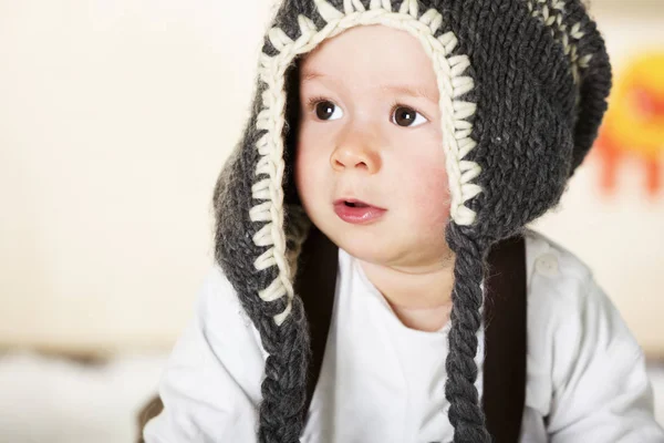 Baby boy with grey cap looking innocently. — Stock Photo, Image