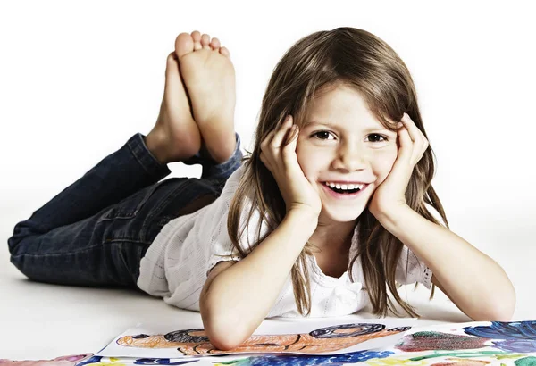 Adorable girl with drawings in studio. — Stock Photo, Image