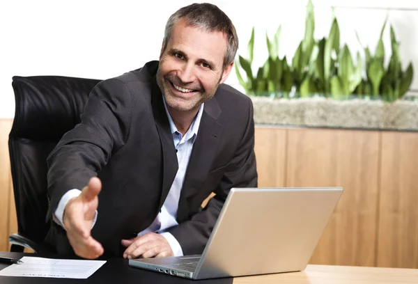 Friendly office manager stretching out hand. — Stock fotografie