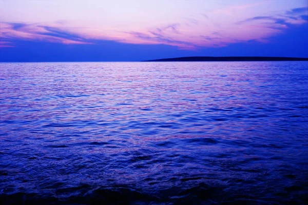 Purple and blue color tone sea water surface and horizon line at the sundown — Stock Photo, Image