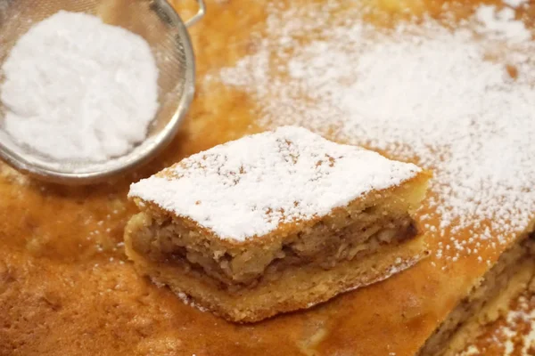 Makkie met poedersuiker op gebakken biscuit — Stockfoto