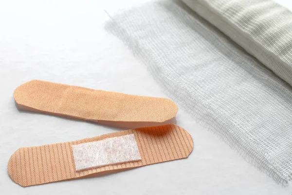 Adhesive bandages and bandage on a light background. Professionally photo with place for text. Medicine