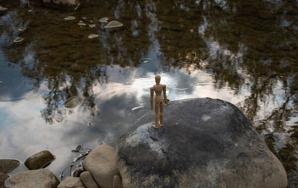 Articulated little man contemplates