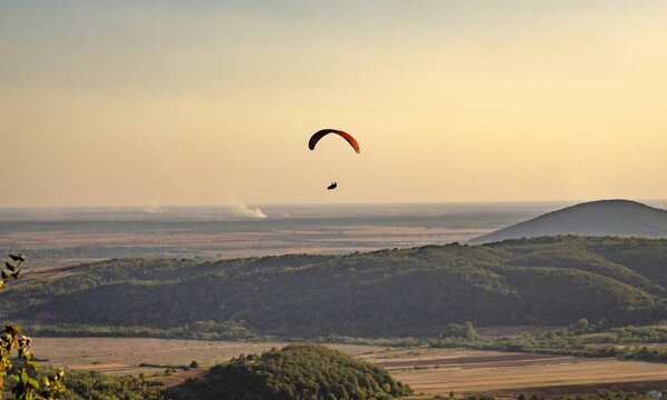 Paragliders soar in the sky