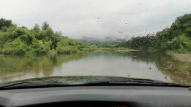 Yağmurda bir dağ nehrinde SUV