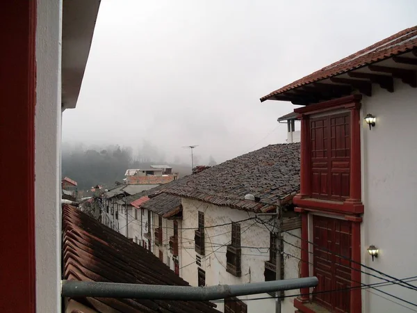 Tile roofs and colonial-style balconies in the city of Chachapoyas on a cloudy sunrise before the rain