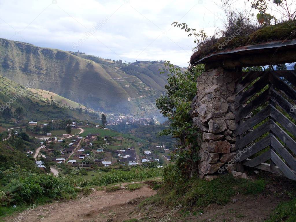 Rural road to the Leymebamba museum, wooden gate and panoramic view of the fields surrounding the city