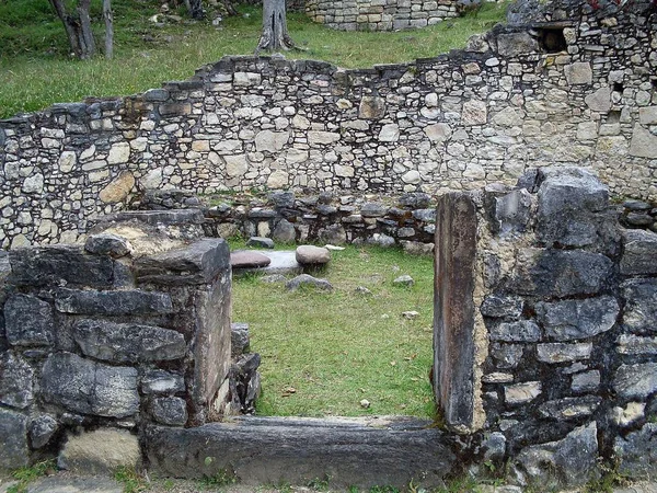 Interior of a circular house on the second level of the Kuelap fortress seen from the entrance door, fuller and mortar