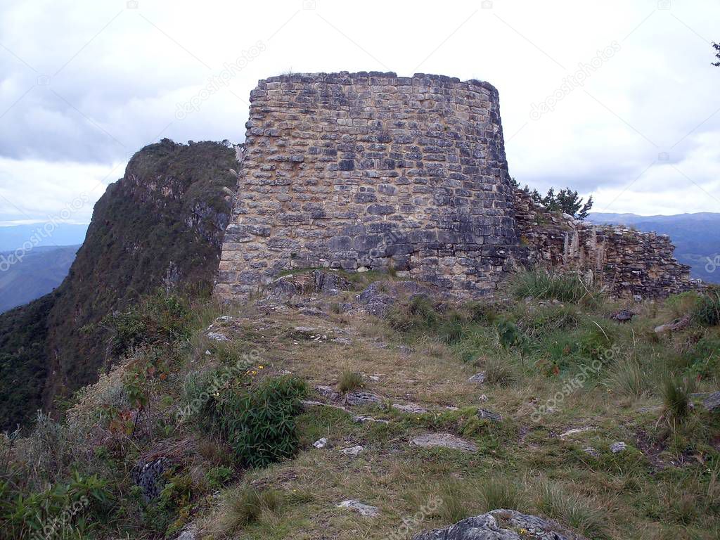 Solid ceremonial building located at the north end of the site of the Kuelap fortress and vegetation. Strategic location