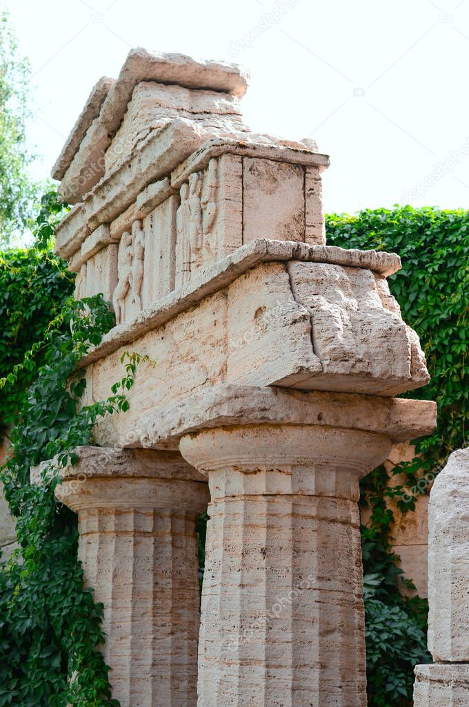 Decorative Greek Ruins in the park. Landscape Design Elements
