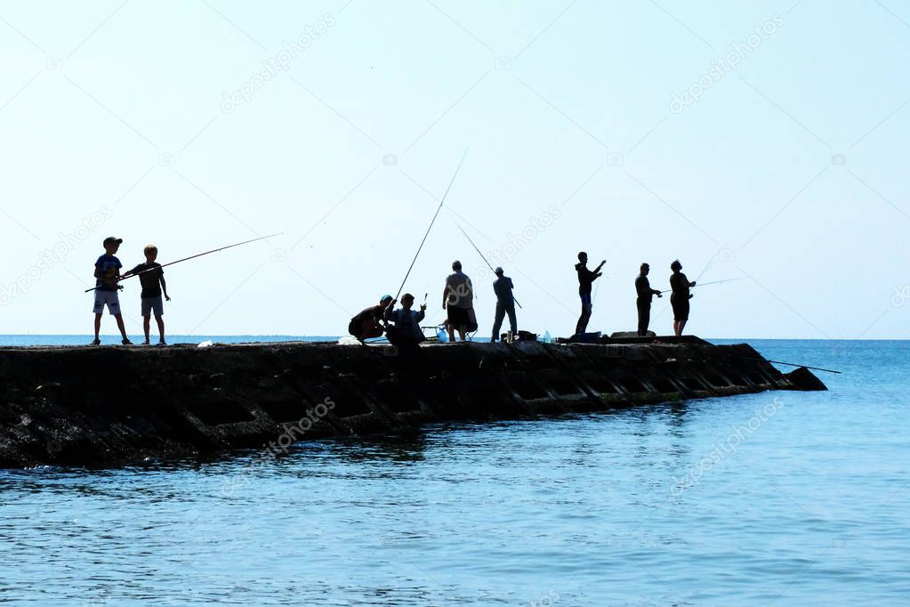 fishermen, children with fishing rods at sea
