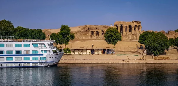 River Cruise Boat on The Nile River Next to the Temple of Edfu in Egypt