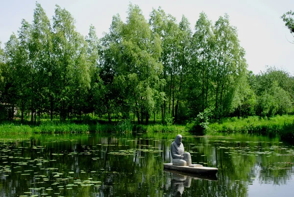 The spring pond and sculpture of a fisherman