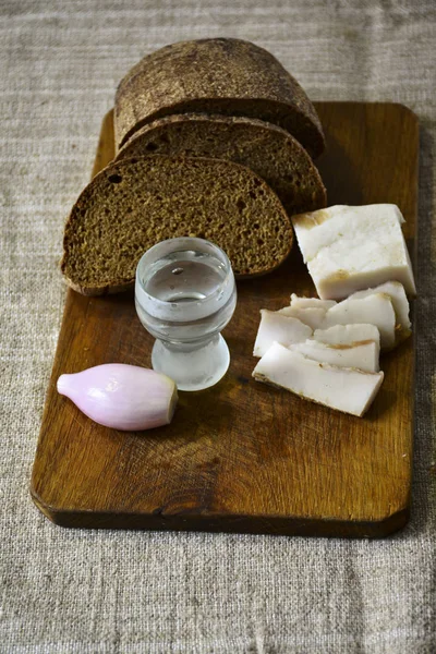 Freshly Baked Bread Wooden Cutting Board Bacon Onions Shot Vodka — Stock Photo, Image