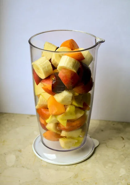 Making fresh smoothie in an apricot, plum, peach, apple and banana blender. A smoothly made smoothie is a great drink with a lot of vitamins and minerals. Great for diet and vegetarians.
