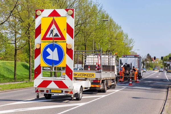 Road works with trucks and traffic signs — Stock Photo, Image